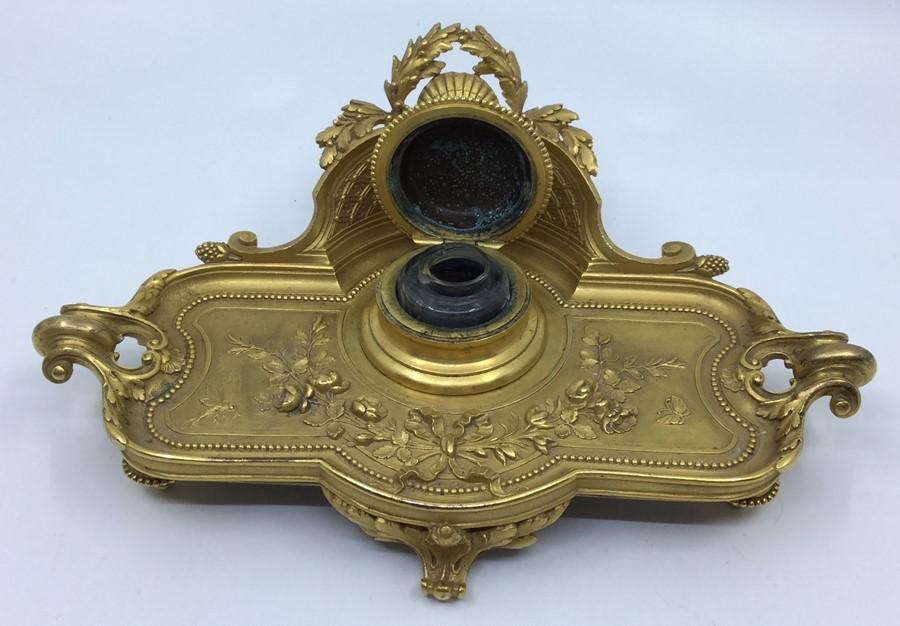 A 19th Century ormolu shape rectangular inkwell on stand, the raised ...