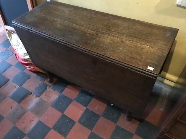 A George III country oak drop leaf gate leg table, pad feet, width