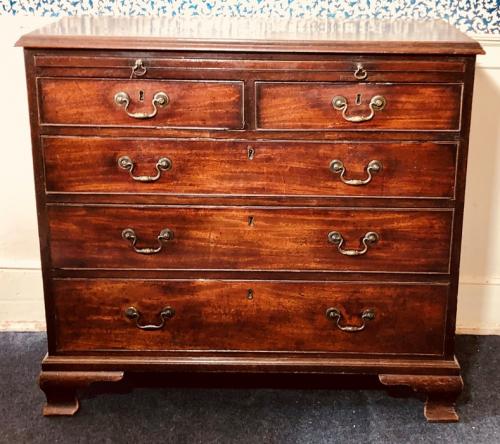 Lot - A George III mahogany bachelors chest the cross banded