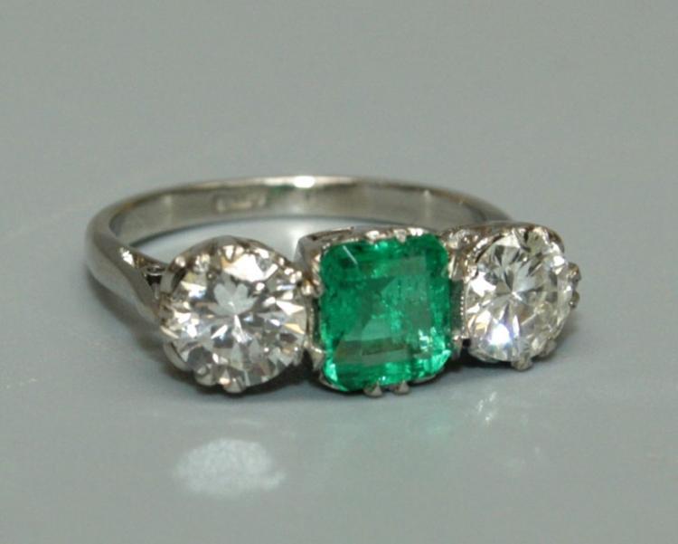 A Columbian emerald and diamond three stone ring, the central octagonal ...