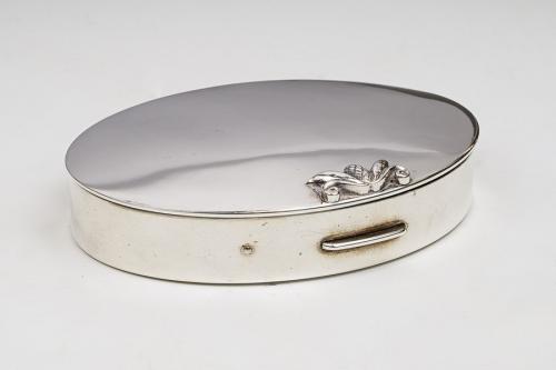 A Georg Jensen oval compact, the cover with raised stylised bud finial, fitted interior, the engine turned stamped: Georg Jensen Inc USA