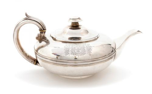 A George IV silver melon shaped teapot, with reeded mid-rib, with C-scroll reeded handle, the hinged cover with stylized pagoda finial, on rim foot, the body engraved with Arms within shield and outer cartouche, hallmarked by Rebecca Emes and Edward Barnard, London, 1822, 22.42 ozt (697 grams)