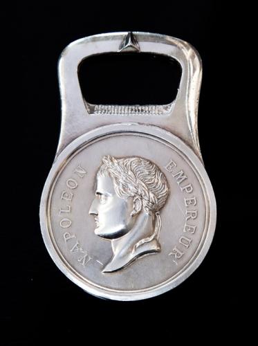 A French mid 20th century silver-plate bottle opener by Christofle, the central section with a medallion depicting Napoleon in profile, stamped Christofle Paris - Coll Gallia, in original box (1)