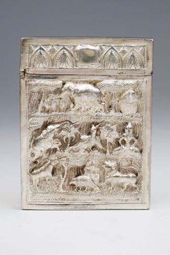 A late 19th Century Indian card case, the body and hinged cover chased with animals with landscape, apparently unmarked