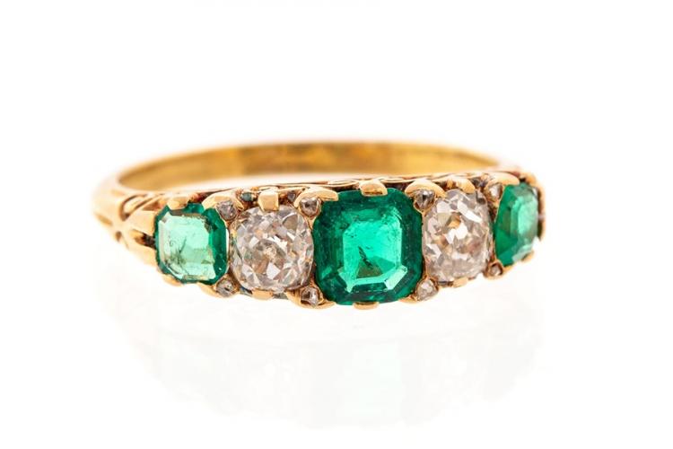 An emerald and diamond five-stone ring, comprising three octagonal ...