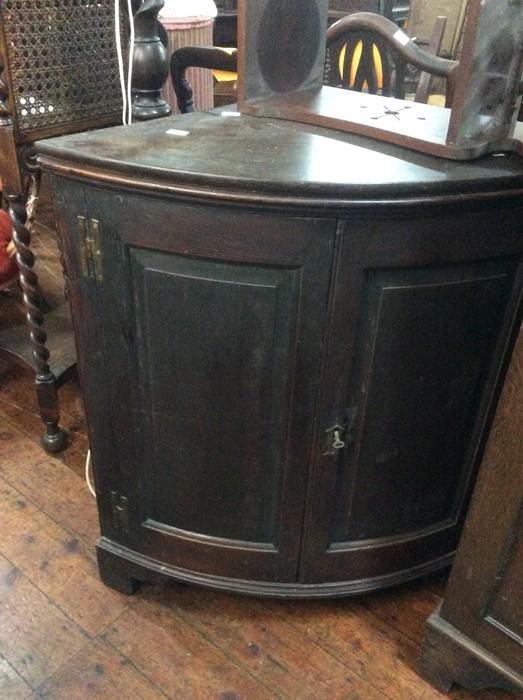 Lot - A George III oak corner cupboard