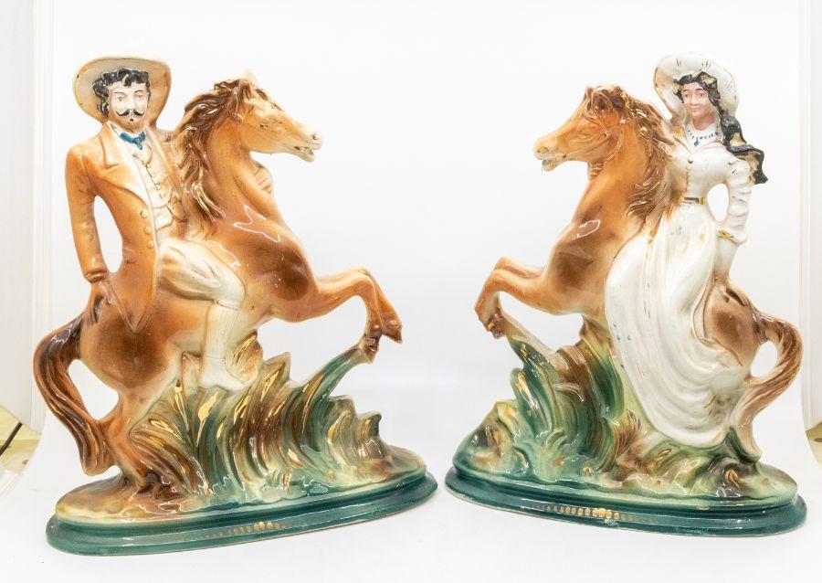 A pair of early 20th century Staffordshire figures of Buffalo Bill and Annie  Oakley on horseback.