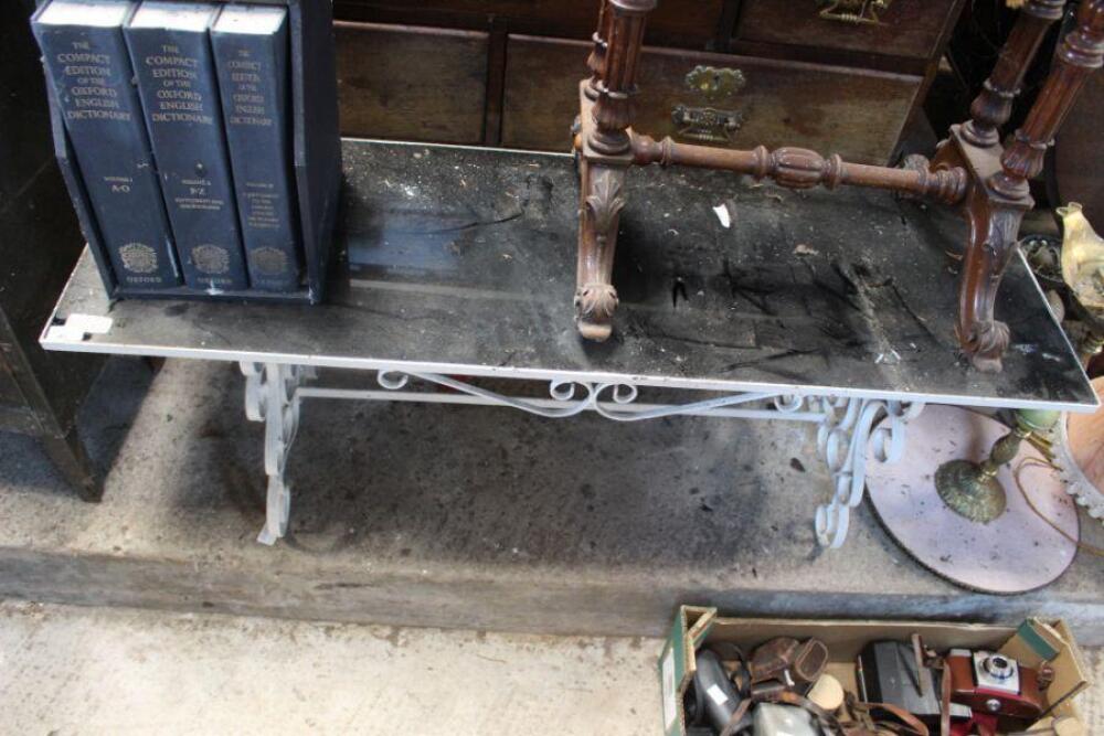 A cast iron, rectangular, white painted patio table