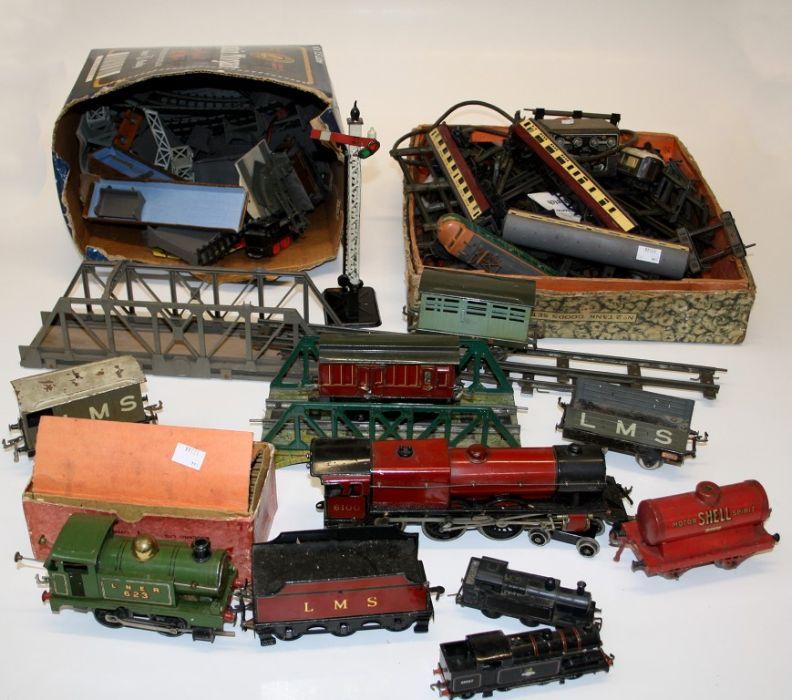 A quantity of Hornby and Basset Lowke railway toy trains, buildings and ...