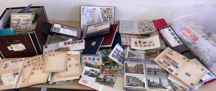 A vast collection of vintage stamps and postcards three boxes and loose