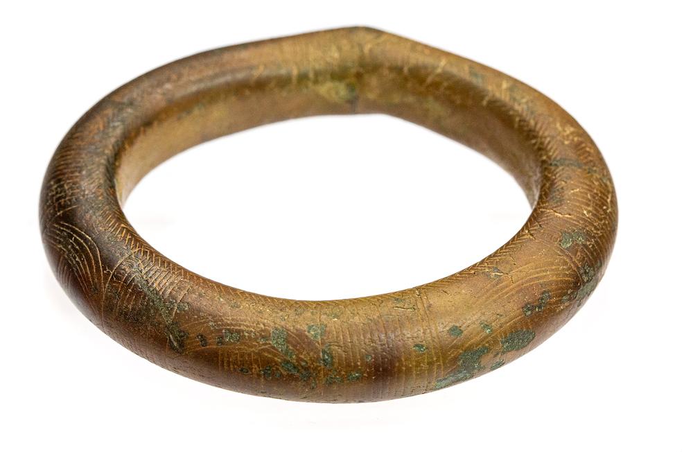 A complete cast copper-alloy bracelet or arm-ring of the so-called 'Liss type', dating to the Middle Bronze Age, c. 1400-1200 BC. bracelet is circular in plan with an oval section,