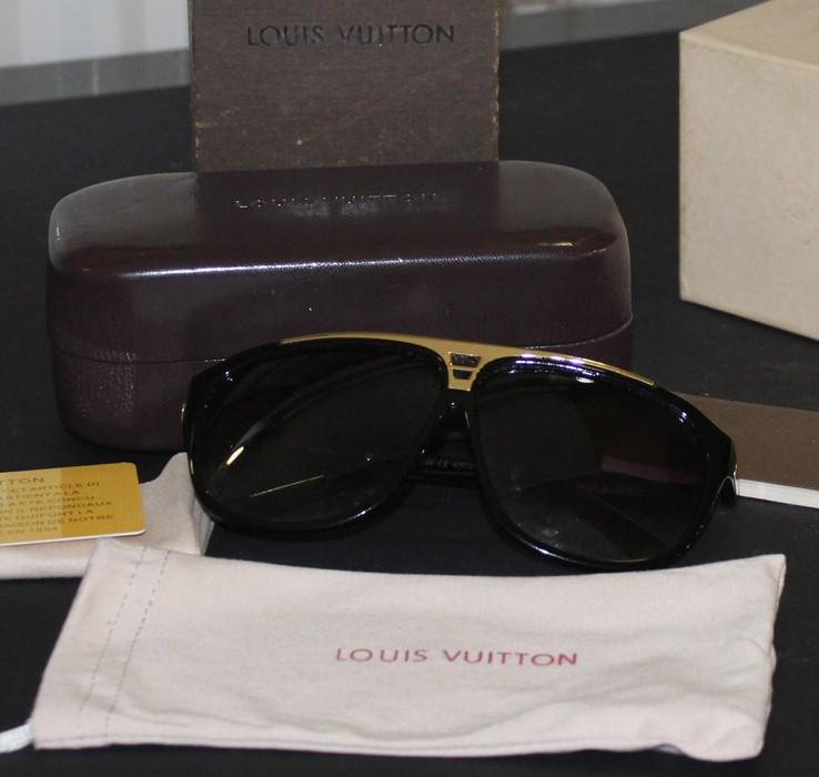 A pair of Louis Vuitton photochromic sunglasses, c.2008, in LV leather glasses  case with dust bag, cloth and booklet, all in LV card box.