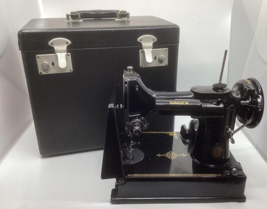 Lot - Vintage portable SINGER sewing machine in an original case