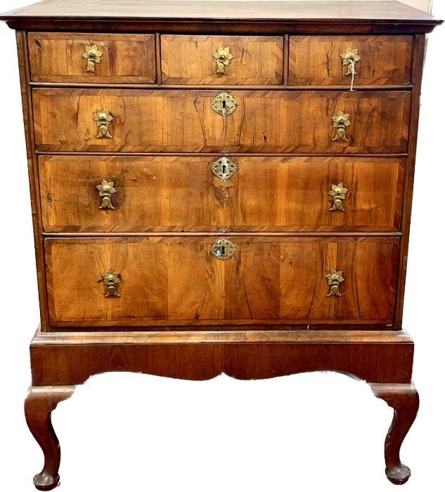 A Queen Anne figured walnut cross-banded chest on stand