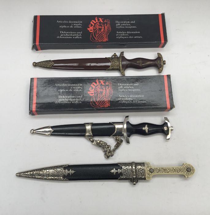 3 reproduction daggers. To include: a boxed German SA dagger by Denix ...