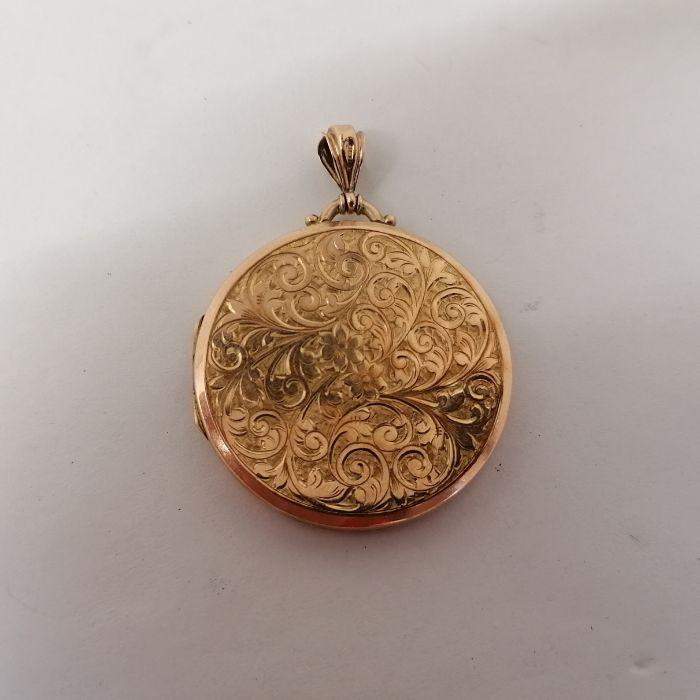 An early 20th century 9ct gold large round locket. Marked for