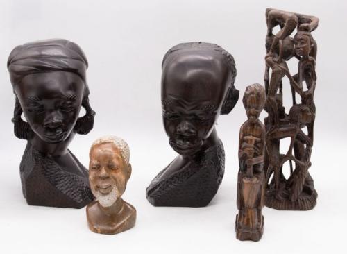 A small collection of Tribal items, most likely tourist pieces, to include; a pair of ebonised wood busts of a man and a woman, a stone smaller bust of a man, a sculpture of a sitting lady and a multiple child sculpture.
 Tallest approx. 27cm high.
 Further Details: Some scratching, wear, slight cracking to parts.