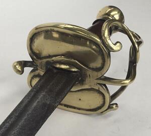 An 18th century English or possibly Dutch small sword.
 Brass kidney shaped double lobed cross guard, with brass knuckle bow and quillon.
 Brass pommel into which the knuckle bow is fitted.
 Polished wooden handle of octagonal cross section.
 Single edged - 5