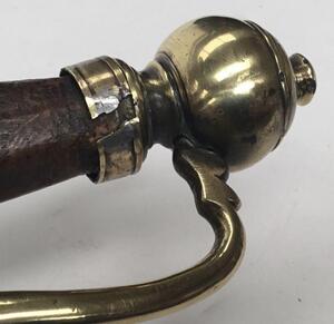 An 18th century English or possibly Dutch small sword.
 Brass kidney shaped double lobed cross guard, with brass knuckle bow and quillon.
 Brass pommel into which the knuckle bow is fitted.
 Polished wooden handle of octagonal cross section.
 Single edged - 6