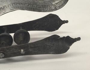 A 17th century Indian Katar from the Vijayanagara Empire.
 Multi fullered double edged blade.
 Reinforcing plates from the ricasso to both sides of the blade, both of which appears represent a bird of prey,
 Curled sail shaped hand guard with chased decor - 8