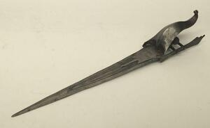 A 17th century Indian Katar from the Vijayanagara Empire.
 Multi fullered double edged blade.
 Reinforcing plates from the ricasso to both sides of the blade, both of which appears represent a bird of prey,
 Curled sail shaped hand guard with chased decor - 11