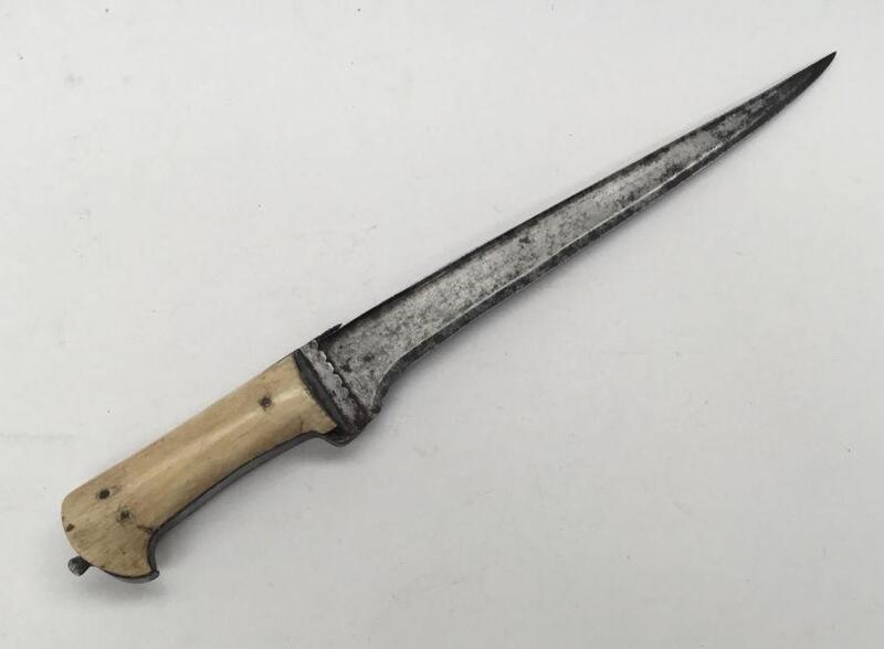 A 19th century Indo-Persian Pesh-Kabz dagger.
 Straight single edged blade, un-fullered, with T cross section along the spine.
 Scalloped design to the ricasso on both sides.
 Bone slab grips, secured with 3 rivet to each side.
 Approximately 42cm length.