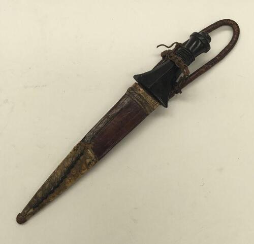 A late 19th / early 20th century Nubian Sudanese arm dagger or Loi Boi.
 Possibly of the Battle of Omdurman period.
 Ebony handle of waisted form, with ring turned decoration.
 Double edged blade with simple line decoration and Arabic engraved inscription