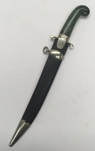 An unusual jade handled dagger, with associated scabbard.
 Nephrite jade handle with nickel mount and cross guard.
 Steel single edged piped back blade.
 The scabbard would appear to be a fabric covering a base material and then waxed or lacquered over th