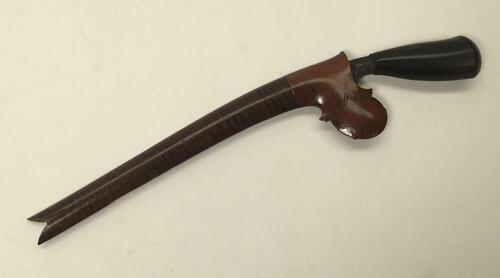 A late 19th / early 20th century Malayan Bade Bade knife.
 Hardwood ebonised handle, with single edged long and narrow steel blade.
 Complete with a carved tiger wood sheath.
 Approximately 26.5cm length in scabbard - blade length 17.5cm.
 Condition: some