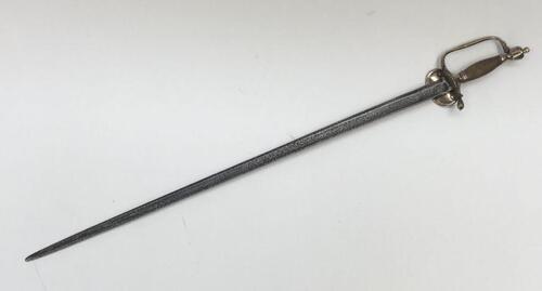 A 1796 pattern infantry officer's sword.
 Brass fold down guard, knuckle guard and pommel.
 Wooden handle that would of formally had a wire binding around it.
 Steel single edged blade, with fuller to both sides and flat spine.
 No visible makers marks or