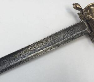 A 1796 pattern infantry officer's sword.
 Brass fold down guard, knuckle guard and pommel.
 Wooden handle that would of formally had a wire binding around it.
 Steel single edged blade, with fuller to both sides and flat spine.
 No visible makers marks or - 7