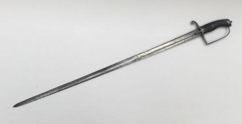 A British late 18th century infantry officers sword, circa 1790.
 Steel guard with decorative feathered langets and curled quillon.
 D shaped knuckle guard leading up to a flattened pommel with decorative finial.
 Ribbed leather grip with copper wire binding.
 Single edged blade with flattened spine, one large and one small fuller.
 Decorative engraving to both sides of the blade, and partly along the spine.
 No apparent makers marks.
 Approximately 86.5cm length.
 Condition: generally good.
 Mu