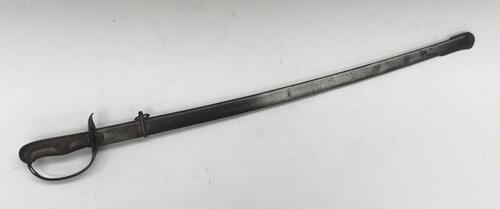 A scarce Japanese M1889 Type 32 NCO’s sword Otsu.
 Steel guard with chequered backpiece and chequered wooden grip.
 Slot to hilt near the pommel to allow the fitting of a sword knot.
 Blade release catch fitted to the handle.
 Steel, slightly curved singl