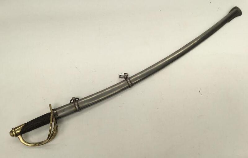 U.S. Civil War era M1860/M1862 cavalry troopers sword by MFG Co of Chicopee, Massachusetts.
 Brass 3 bar guard and pommel, with stamped serial number 14506.
 Leather bound grip with twisted copper wire binding.
 Single edged curved blade with flat spine a