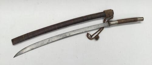 A 19th century Burmese Sword (Dha).
 Rounded wooden grip with white metal pommel and guard.
 Steel slightly curved single edge blade, with false edge near the tip.
 Polished wooden scabbard with multiple wire bindings along its length.
 Rope binding / bal