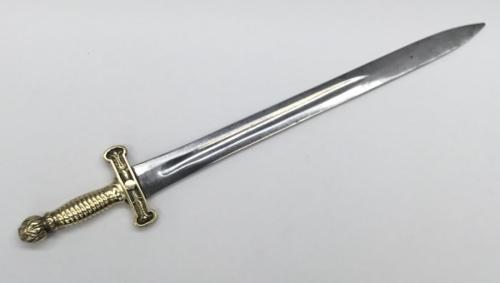 A 19th century Gladius style short sword.
 Cast brass hilt, with foliage detail, ribbed handle, and acanthus leaf pommel.
 Steel doubled edged blade with single fuller.
 No apparent makers marks.
 Approximately 65cm.
 Condition: generally good.
 Brass hilt is solid and displays just normal service wear.
 The blade has some mottled darker areas and has a pitted surface.
 It would appear that the blade has been polished in the past.