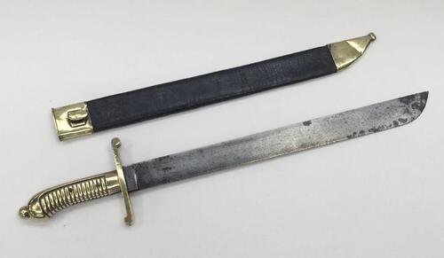 A 19th century 1855 pattern Imperial Prussian Faschinenmesser Fascine Knife / short sword or Pioneer’s sword.
 Brass cross guard with curled quillon, solid brass ribbed grip, backpiece and pommel.
 Steel single edged blade, with flat spine.
 Complete with