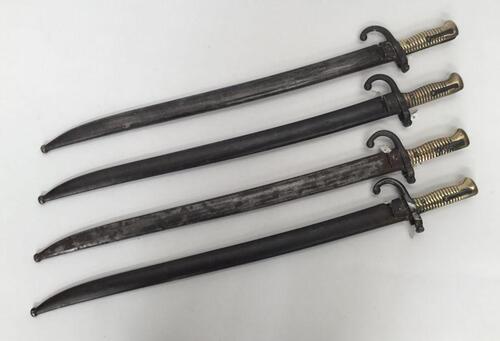 A selection of 19th century French Chassepot bayonets.
 4 examples, including pieces dated 1871, 1867, 1872, and 1870.
 Each with the usual ribbed brass grip, and pommel with spring loaded rifle clip.
 Steel cross guard with curled quillon, and a curved s