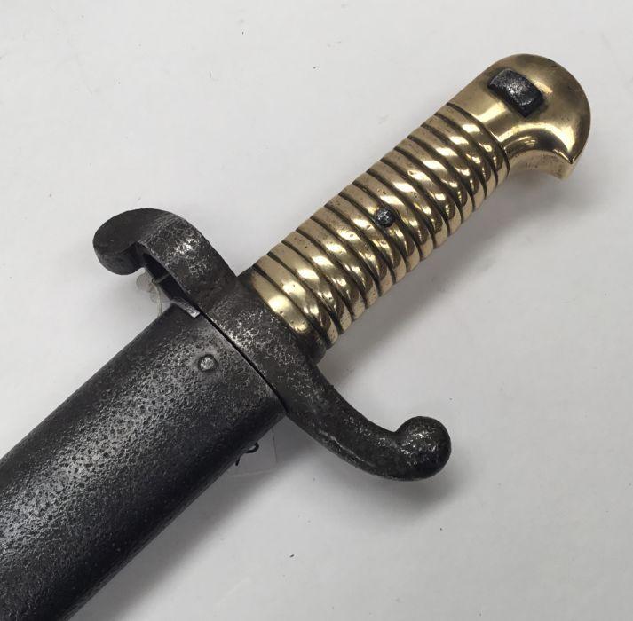 A French 1842 pattern Yatagan sword bayonet. Ribbed brass grip with ...