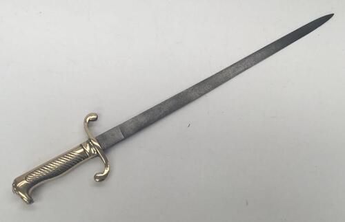 A 19th century Prussian M1864 NCO’s short sword or side arm.
 Brass handle with diagonally grooved grip to one side, and a beak shaped pommel.
 Curled quillons to the cross guard.
 Straight steel single edged blade, un-fullered with a flat spine.
 No appa