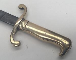 A 19th century Prussian M1864 NCO’s short sword or side arm.
 Brass handle with diagonally grooved grip to one side, and a beak shaped pommel.
 Curled quillons to the cross guard.
 Straight steel single edged blade, un-fullered with a flat spine.
 No appa - 4