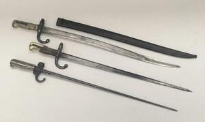 3 19th century French sword bayonets.
 To include, a M1886 Lebel, with hooked quillon and cruciform blade (no scabbard).
 A Gras bayonet, with wooden grips and brass pommel, dated 1876 to the flat spine (no scabbard).
 And a Chassepot bayonet, with ribbed