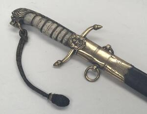 A 19th century Victorian British Navy midshipman’s dirk.
 Brass cross guard with integral release catch, fouled anchor langet, and acorn tipped quillons.
 Lion’s head pommel, with its mane forming the backpiece.
 Wire binding to the grip, which would of o - 3