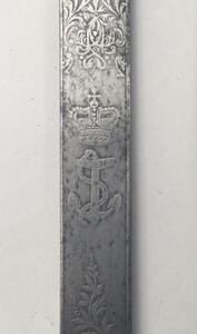 A 19th century Victorian British Navy midshipman’s dirk.
 Brass cross guard with integral release catch, fouled anchor langet, and acorn tipped quillons.
 Lion’s head pommel, with its mane forming the backpiece.
 Wire binding to the grip, which would of o - 9