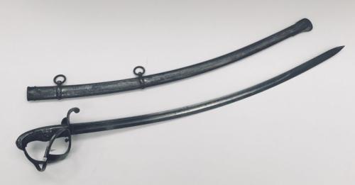 A very rare mid 19th century Royal Engineer’s drivers sword.
 Open single bar steel guard, with curled quillon, backpiece and pommel.
 Leather contoured grip, which likely would have had wire binding when first made.
 Curved single edged blade, with flat spine and single fuller.
 Complete with steel scabbard, with 2 suspension rings.
 The blade carries both German / Prussian issue marks for 1850, plus British inspection marks, indicating it was inspected in Liege.
 The manufacturers mark is for