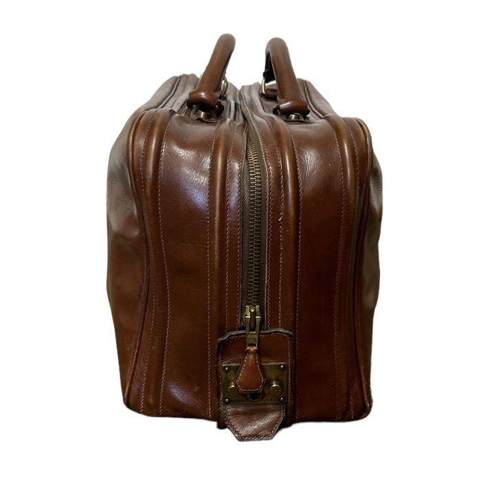 A rare mid century vintage Hermes travel bag in a mid tone brown leather  with two top handles and a brass Eclair zipper with leather pull (up until  the 90s Eclair zippers