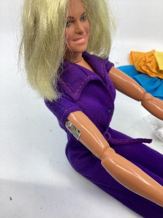 A Lady Penelope doll and a Bionic woman doll with small holdall of  accessories.