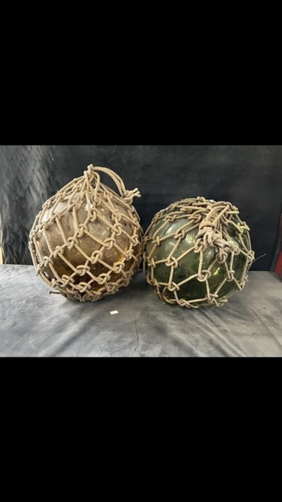 2 x large glass fishing floats complete with original rope. One amber, one  green. Approximately 16-17 high including rope rope.