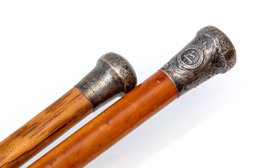 A malacca walking cane, the silver pommel with Royal Warwickshire Regt  insignia, (hallmarks rubbed), length 90cm, and another silver topped walking  cane (2)