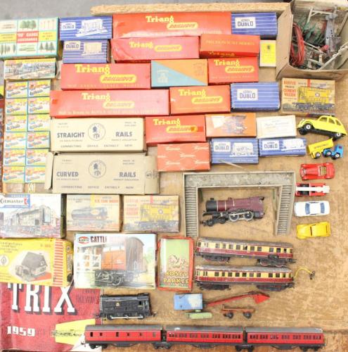 Model Railway: A collection of assorted model railway to include: two unboxed locomotives, various boxed rolling stock including Triang examples, as well as various boxed Merit figures, and other unboxed coaches. Playworn condition. Please assess photographs. (one box)